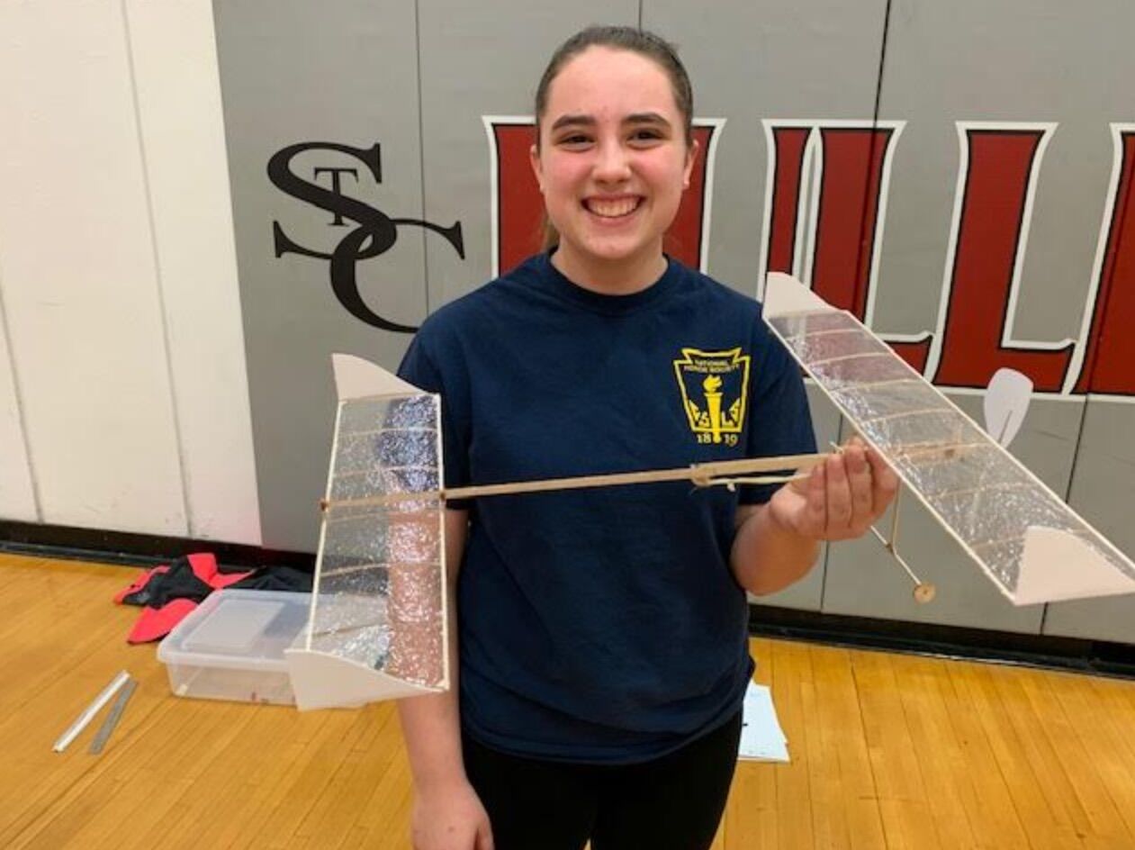 Allison Bright holds an aircraft